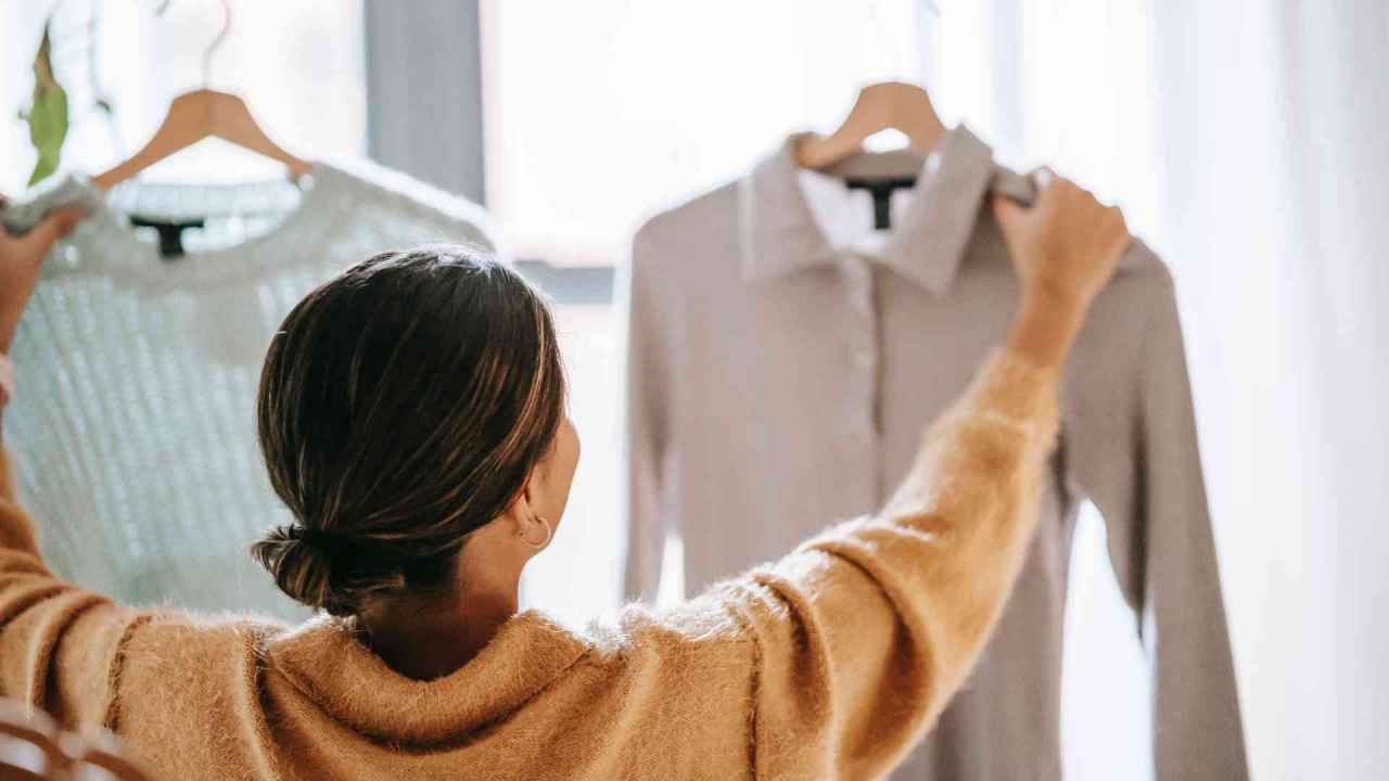 Woman Comparing Clothes Sales Channel Integration